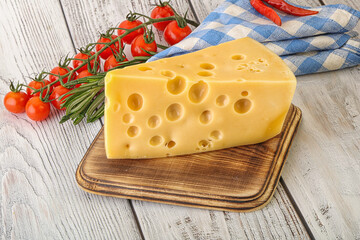 Maasdam cheese piece over board