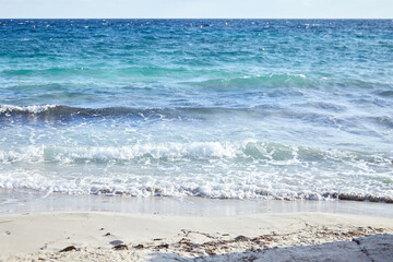 Sand beach, summer sea with blue sky. Sea water with white wave. Cala azzurra beach, Favignana island, Trapani, Sicily, Italy. A beautiful seascape