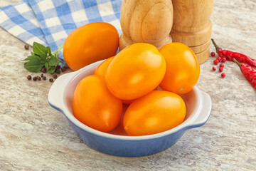 Sweet ripe yellow tomato in the bowl