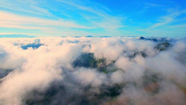 Aerial view over dense fog and beautiful mountains during sunrise. landscape of tropical rainforest in winter. Mae Hong Son Province, Northern Thailand. travel and nature concept. 4K
