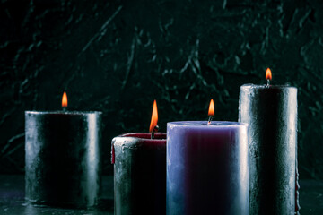 Burning candles on a dark background, mysterious ritual