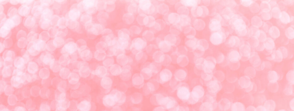 Blurred light pink with white sparkling background from small sequins, macro. Rose defocused backdrop