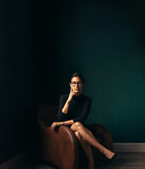 Independent business woman sitting in chair