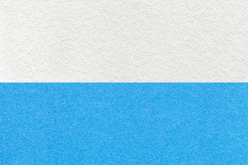 Texture of craft white and light blue paper background, half two colors. Vintage dense cerulean cardboard.