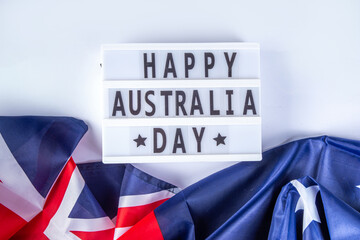 Australia Day greeting card Background with  australian flag, silver stars, lightbox with text Happy Australia day, paper red, blue, white decor, over white background copy space