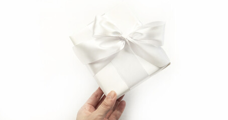 Gift white box with a bow on a white background. Holiday concept.Holiday concept, gift.
