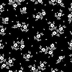 Cute floral pattern. Seamless vector texture. An elegant template for fashionable prints. Print with  small white flowers and leaves. black background.