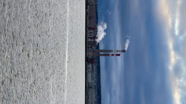View of the tall chimneys of an industrial enterprise with a chimney polluting the atmosphere. The plant for the production of strategic intercontinental missiles "Topol-M". Russia, Votkinsk 2022