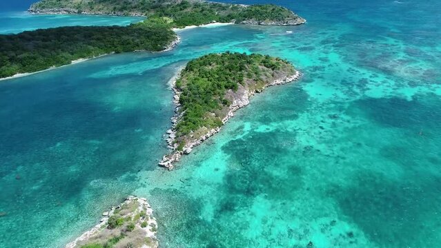 Small reef islands and coastal reefs in bright sunny day. Aerial view