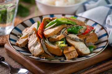 Homemade stir-fried dried beancurd with dried fish and green chili.