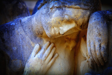 Fragment of an ancient stone statue of sad and desperate woman on tomb as a symbol of death and the...