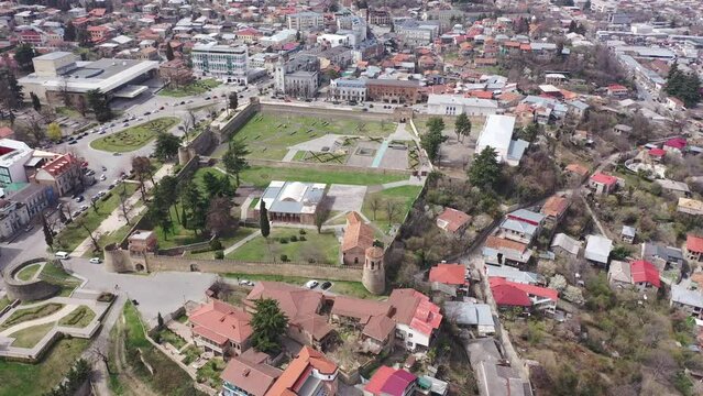 Panoramic aerial view of Telavi cityscape with residential districts and architectural complex of Batonis Tsikhe Castle in spring, Georgia