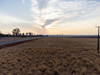 large highway in dry grass scenery amidst the farms