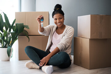 Boxes, black woman and homeowner with keys, to new home and happiness in home. Property, African...