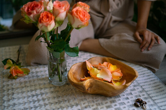 Young woman intentionally making flower infused herbal bath