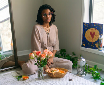 Young woman sitting with her flowers