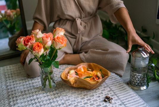 Young woman intentionally making flower infused herbal bath