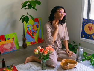 Young woman putting on herbal fragrance
