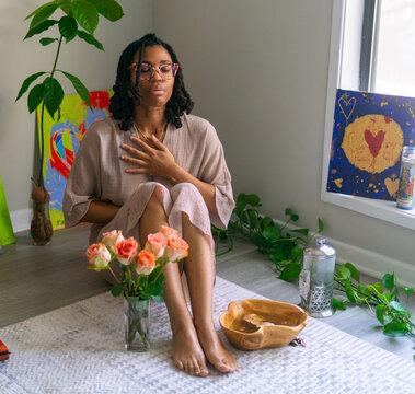Young woman praying in her home