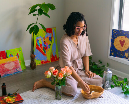 Young woman intentionally making flower infused herbal bath
