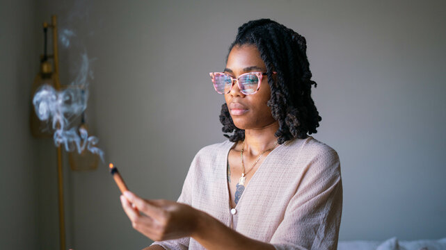 Young woman burning incense