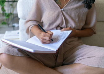 Young woman journaling in her home
