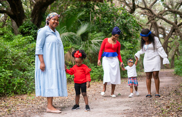 Fototapeta premium Women and toddlers walking in the park