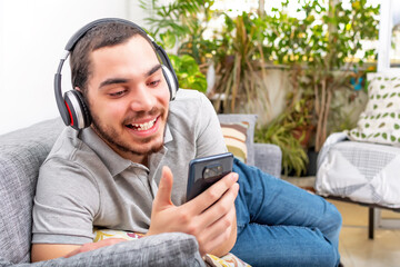 Happy guy enjoying free weekend leisure time chilling alone at home.