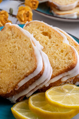 Close up view of lemon cake on plate with lemons on side. Delicious fresh homemade dessert 