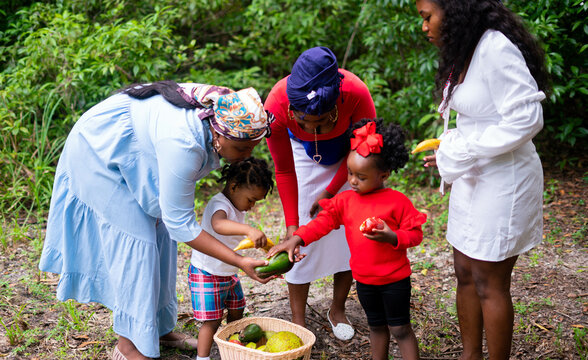 Women and children with fruit and vegetable basket