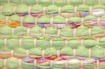 Closeup of handwoven rug rug in warm pastel colors