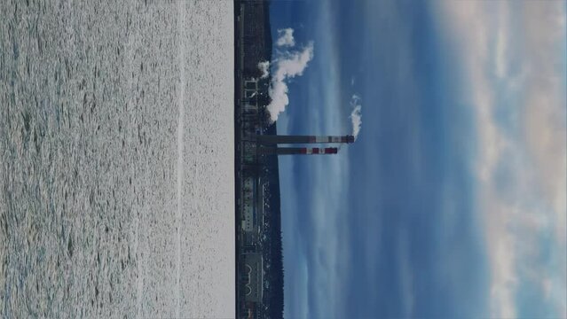 View of the tall chimneys of an industrial enterprise with a chimney polluting the atmosphere. The plant for the production of strategic intercontinental missiles "Topol-M". Russia, Votkinsk 2022