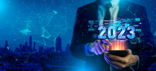 Smart businessman smartphone show digital dashboard in 2023 on hologram city background.3D...