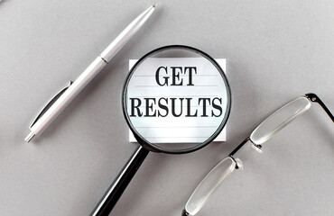 GET RESULTS text written on a sticky with pencil and glasses text written on a sticky with pencil and glasses