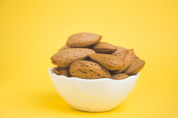 almonds in a plate on a yellow