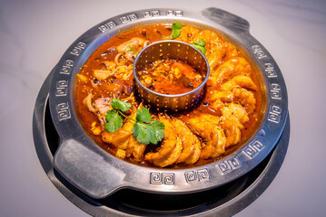 Prawn and Squid Hot Pot. Flavorful meat and broth served inside a large metal pot. Chinese delicacy.
