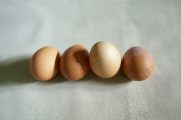 a collection of raw eggs on a white concrete background
