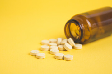 headache pills isolated on yellow