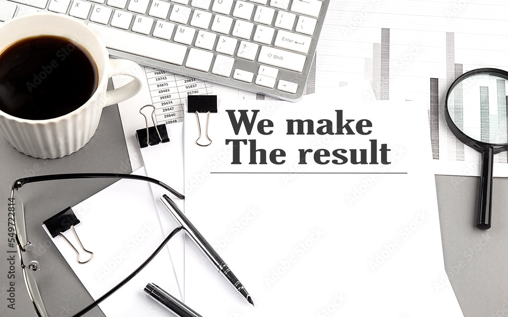 Poster we make result text on a paper with magnifier, coffee and keyboard on grey background