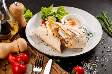 Tasty dish of pita with meat and vegetables on wooden background