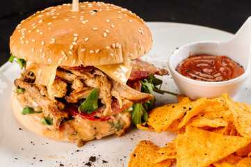 Tasty fresh burger with shopped meat and chips on wooden background
