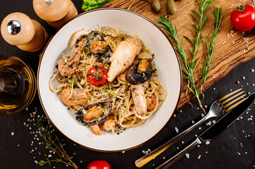 Tasty pasta with a seafood and vegetables on wooden background