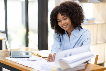 Successful african american accountant business woman work documents tax on laptop computer in office. finance investment economy and marketing research concept.