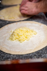 Closeup hand of chef baker making pizza at kitchen. The process of making pizza. cooking italian pizza