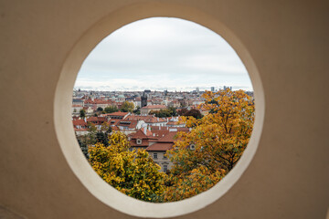 Autumn view of Prague seen through a round hole