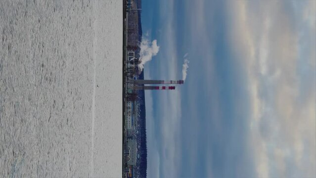 View of the tall chimneys of an industrial enterprise with a chimney polluting the atmosphere. The plant for the production of strategic intercontinental missiles "Topol-M". Russia, Votkinsk 2022