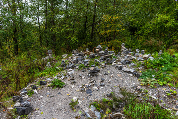 Pyramids of stones in Karelia. Pyramids of stones on background of green forest. Natural stones on top of each other. Balancing stones in the forest.