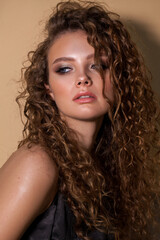 young model with professional make up and curly hair