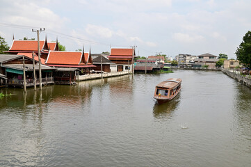 Fototapeta na wymiar BANGKOK, THAILAND - December 02, 2022 : Tourist Passenger Boat leading tourists to view the houses along the canal and the ways of villagers along the canal in the Chao Phraya River Canal.