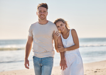 Couple, happy and beach in portrait for love, bonding and walking together on vacation, holiday or honeymoon. Man, woman and romance on adventure, walk or relax by ocean in summer, waves and smile
